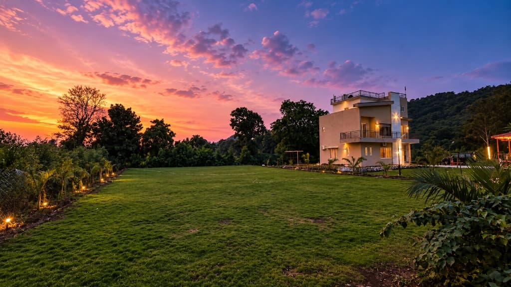 Saanjh at dusk, lawn in front and hills behind.
